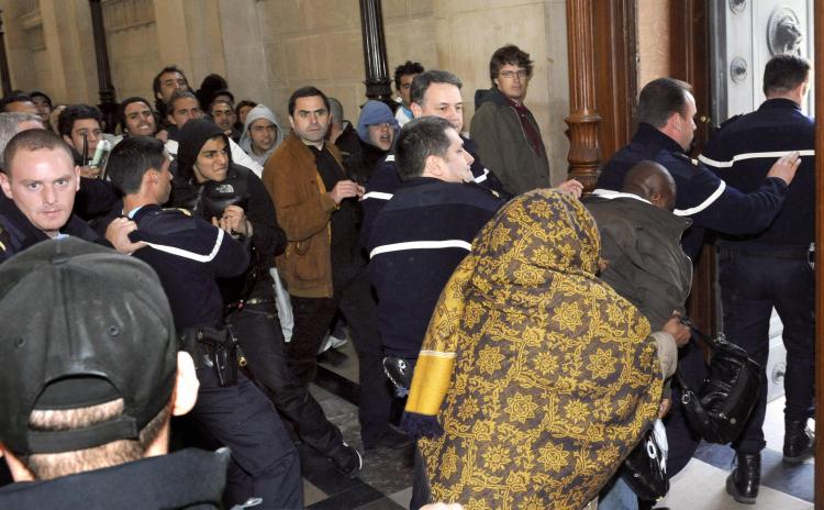 The mother and the brother of Youssouf Fofana leaves Paris' courthouse escorted by policemen as they are threatened by several people, on April 29, 2009, at the end of an audience on the opening day of the trial of Youssouf Fofana. (Stephane de Sakutin/AFP/Getty Images) The mother and the brother of Youssouf Fofana leaves Paris' courthouse escorted by policemen as they are threatened by several people, on April 29, 2009, at the end of an audience on the opening day of the trial of Youssouf Fofana. (Stephane de Sakutin/AFP/Getty Images)