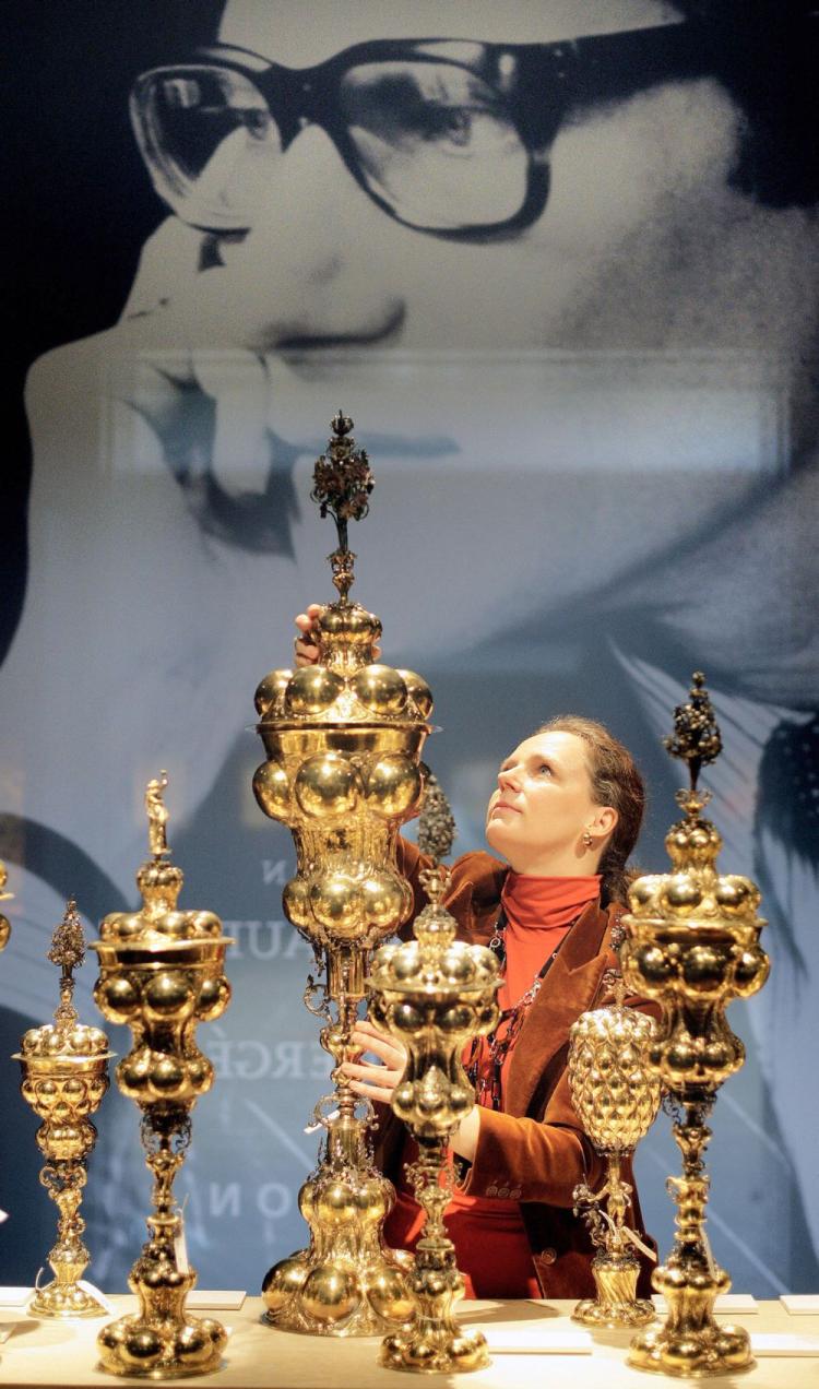 A Christie's employee poses with a a German parcel-gilt table fountain during a tour of an exhibition of 'The Collection of Yves Saint Laurent and Pierre Berge' at Christie's auction house in central London, on Jan. 29, 2009. (Shaun Curry/AFP/Getty Images) A Christie's employee poses with a a German parcel-gilt table fountain during a tour of an exhibition of 'The Collection of Yves Saint Laurent and Pierre Berge' at Christie's auction house in central London, on Jan. 29, 2009. (Shaun Curry/AFP/Getty Images)