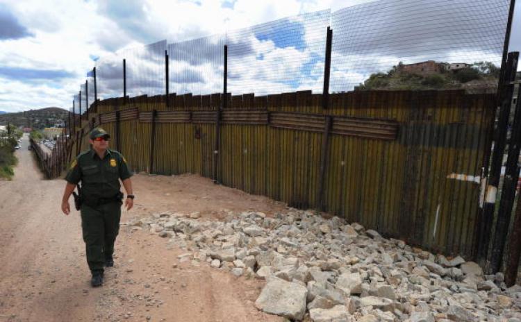A US Border Patrol officer keeps watch over the border fence that divides the US from Mexico in the town of Nogales, Arizona on April 22, 2010. (Mark Ralston/AFP/Getty Images) A US Border Patrol officer keeps watch over the border fence that divides the US from Mexico in the town of Nogales, Arizona on April 22, 2010. (Mark Ralston/AFP/Getty Images)
