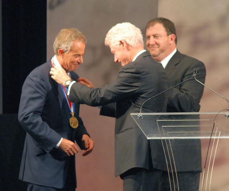 Former U.S. President Bill Clinton (C), along with National Constitution Center's President David Eisner (R), presents former Prime Minister Tony Blair the 2010 Liberty Medal at the National Constitution Center Sept. 13 in Philadelphia, Pennsylvania. Blair won the medal for his work to broker peace in Northern Ireland and Kosovo, and promote peace and economic opportunities in the Middle East and Africa. (William Thomas Cain/Getty Images) Former U.S. President Bill Clinton (C), along with National Constitution Center's President David Eisner (R), presents former Prime Minister Tony Blair the 2010 Liberty Medal at the National Constitution Center Sept. 13 in Philadelphia, Pennsylvania. Blair won the medal for his work to broker peace in Northern Ireland and Kosovo, and promote peace and economic opportunities in the Middle East and Africa. (William Thomas Cain/Getty Images)