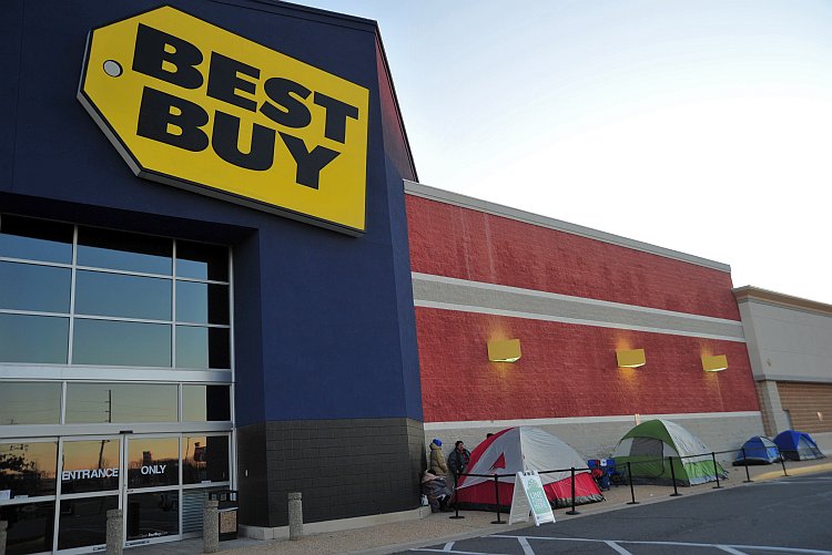 Patrons stand in line in front of a Best Buy store Patrons stand in line in front of a Best Buy store