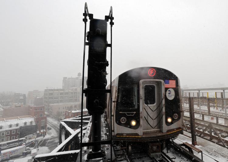 State of Emergency in Massachusetts, New Jersey, Delaware: The F-train pulls into the station at Smith and Ninth street on Dec. 26 in New York City. A winter storm is pounding the East Coast of the United States and is expected to deliver a foot of snow for New York City and New England while snarling post-Christmas travel. (Michael Heiman/Getty Images) State of Emergency in Massachusetts, New Jersey, Delaware: The F-train pulls into the station at Smith and Ninth street on Dec. 26 in New York City. A winter storm is pounding the East Coast of the United States and is expected to deliver a foot of snow for New York City and New England while snarling post-Christmas travel. (Michael Heiman/Getty Images)