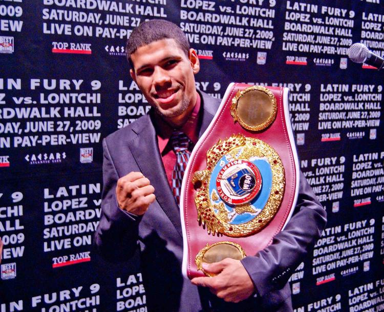 CONTESTED: Juan Manuel â��Juanmaâ�� Lopez holds his junior featherweight champion belt.  (Joshua Philipp/The Epoch Times)