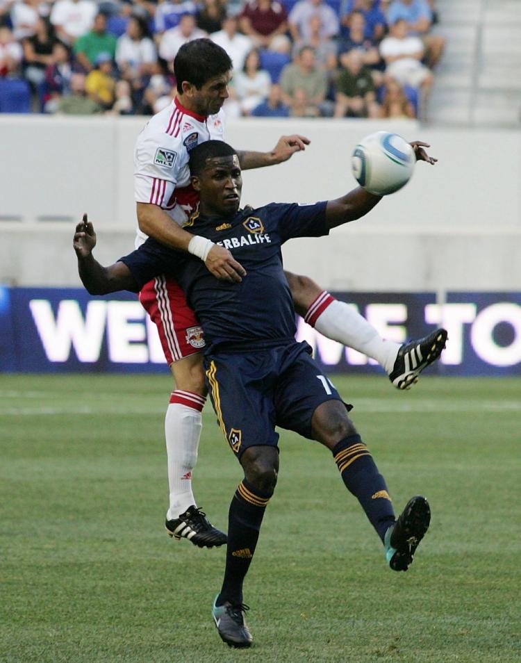 Carlos Mendez (L) of the New York Red Bulls climbs over L.A. Galaxy's Edson Buddle at Red Bull Arena on Saturday. (Andy Marlin/Getty Images)