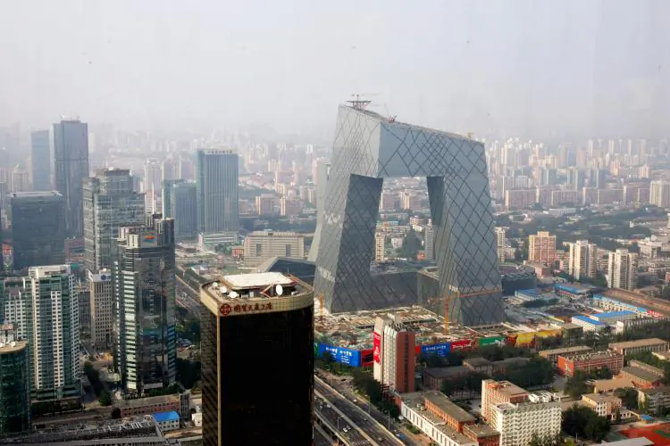 The new angled building of the state-run Chinese Central TV headquarters dominates the surrounding area in Beijing. (China Photos/Getty Images)