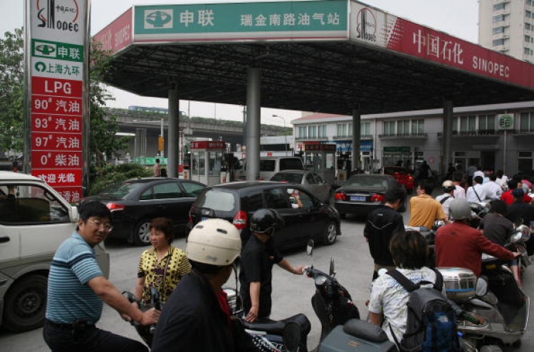Motorcyclists queue to buy fuel at a petrol station on June 6, 2008 in Shanghai, China. On June 19, China's Commission for State Reform and Development issued a notice that beginning on June 20, the cost of domestic refined oil and electricity would be ra (China Photos/Getty Images) Motorcyclists queue to buy fuel at a petrol station on June 6, 2008 in Shanghai, China. On June 19, China's Commission for State Reform and Development issued a notice that beginning on June 20, the cost of domestic refined oil and electricity would be ra (China Photos/Getty Images)