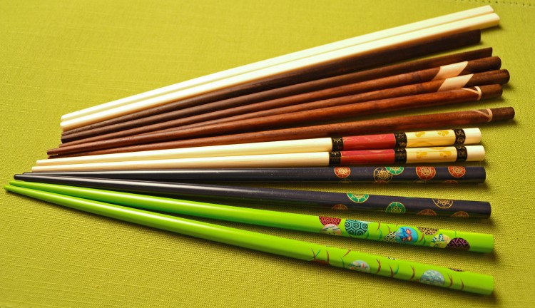 Pictured are a few styles of chopsticks. From front to back, the first three are Chinese-style, tapered and painted bamboo chopsticks; the next three are Japanese-style, stained wood chopsticks (third pair has flat triangular ends); the white pair are made of melamine and are flat and square at top with blunt-tip ends. Although made in China, they are used throughout Asia, especially Vietnam. (Vanessa Rios/The Epoch Times) Pictured are a few styles of chopsticks. From front to back, the first three are Chinese-style, tapered and painted bamboo chopsticks; the next three are Japanese-style, stained wood chopsticks (third pair has flat triangular ends); the white pair are made of melamine and are flat and square at top with blunt-tip ends. Although made in China, they are used throughout Asia, especially Vietnam. (Vanessa Rios/The Epoch Times)