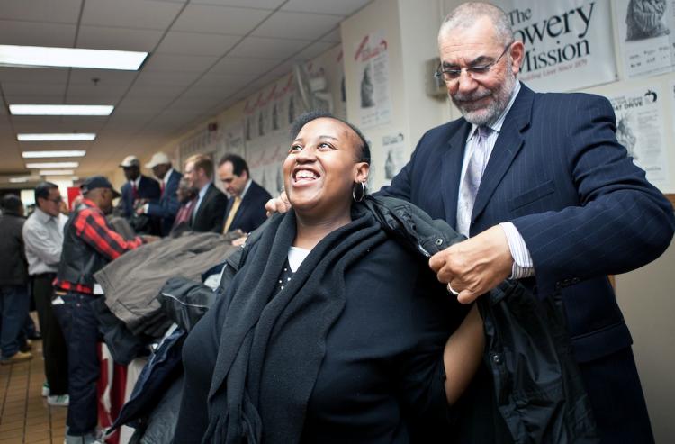 COAT DRIVE: A woman is assisted with a new coat by President and General Manager of WNBC Michael Jack at the Bowery Mission on Wednesday. The New York Cares annual coat drive began Wednesday. (The Epoch Times) COAT DRIVE: A woman is assisted with a new coat by President and General Manager of WNBC Michael Jack at the Bowery Mission on Wednesday. The New York Cares annual coat drive began Wednesday. (The Epoch Times)
