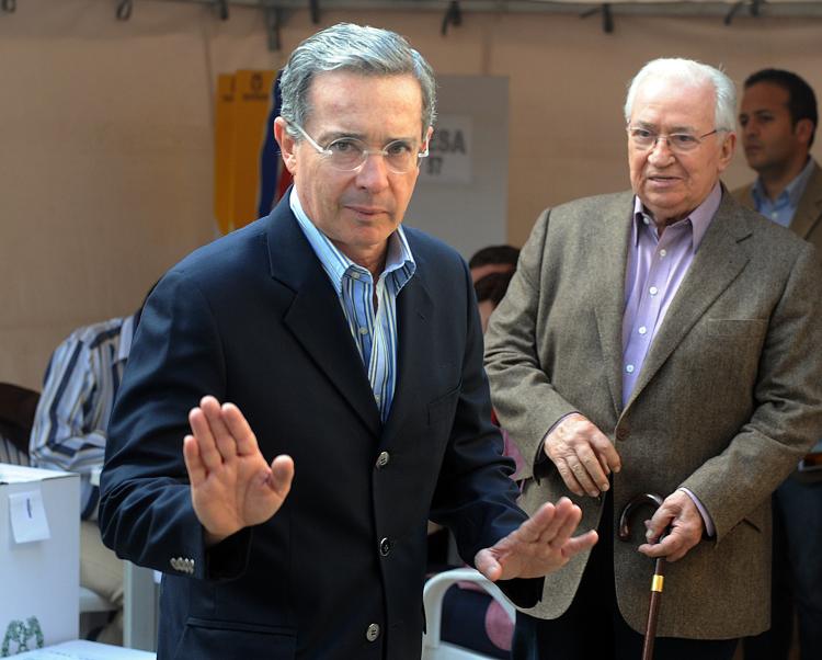 Colombian President Alvaro Uribe waves to journalists after casting his vote during the legislative elections, in Bogota on March 14. Uribe is considering a hostage swap with Colombia's largest rebel group, Farc. (Rodrigo Arangua/AFP/Getty Images) Colombian President Alvaro Uribe waves to journalists after casting his vote during the legislative elections, in Bogota on March 14. Uribe is considering a hostage swap with Colombia's largest rebel group, Farc. (Rodrigo Arangua/AFP/Getty Images)