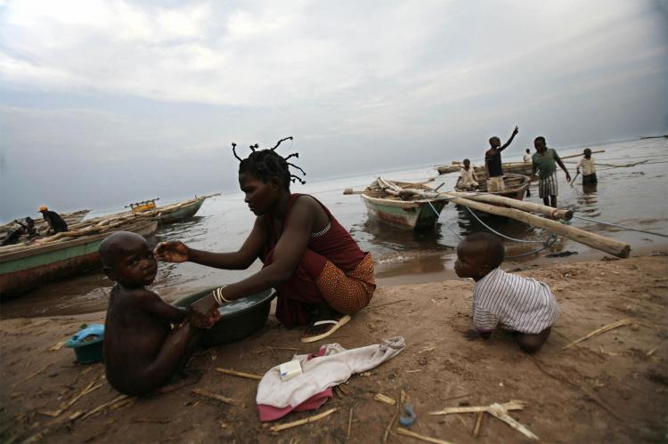A woman gives a bath to her son on the shores of the Lake Tanganyika. Location of an earlier boat accident where thirteen people were killed, and dozens remain missing, after an overloaded barge sank. (Jose Cendon/AFP/Getty Images ) A woman gives a bath to her son on the shores of the Lake Tanganyika. Location of an earlier boat accident where thirteen people were killed, and dozens remain missing, after an overloaded barge sank. (Jose Cendon/AFP/Getty Images )
