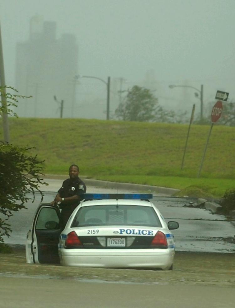 A police officer waits for assistance after his car stalled in flood waters in New Orleans, Louisiana. (Stephen Morton/Getty Images) A police officer waits for assistance after his car stalled in flood waters in New Orleans, Louisiana. (Stephen Morton/Getty Images)