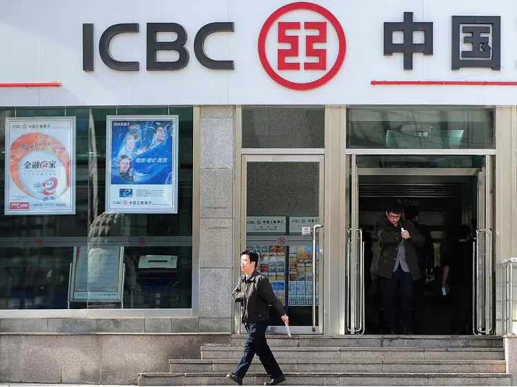 Customers leave a branch of the Industrial and Commercial Bank of China (ICBC) in Beijing in this undated photo.  (Frederic J. Brown/AFP/Getty Images)