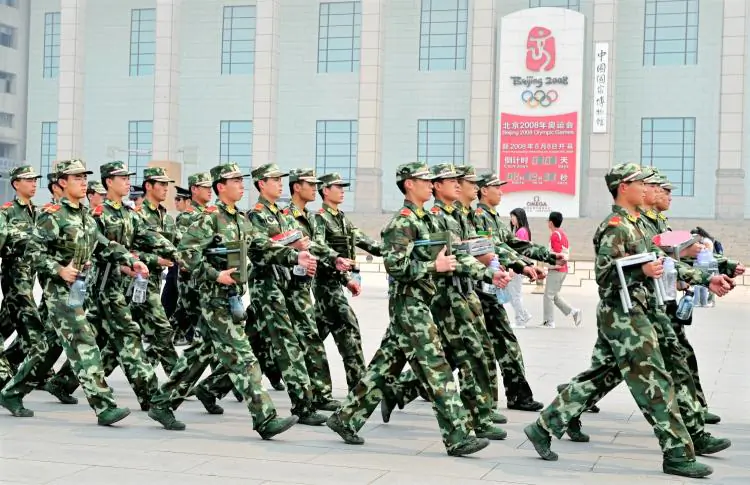 Chinese paramilitary policemen patrol past the Beijing Olympics countdown clock on the edge of Tiananmen Square in Beijing on April 29, 2008. Leading up to the Olympics the Chinese regime cracked down on groups deemed dissidents. (Teh Eng Koon/AFP/GETTY IMAGES)
