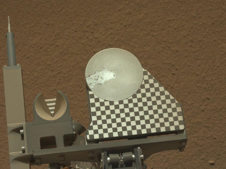 The robotic arm on NASA's Mars rover Curiosity delivered a sample of Martian soil to the rover's observation tray for the first time during the mission's 70th Martian day, or sol (Oct. 16, 2012). (NASA/JPL-Caltech/MSSS) 