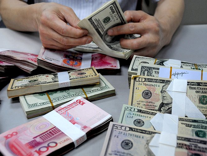 A staff member counts money at a branch of the Bank of China in Lianyungang, Jiangsu Province, China, in this file photo. Because of the currency wars going on between countries like the United States and China, there is a lot of pressure to get away from the dollar as the world's reserve currency, but the Chinese yuan is very far from becoming the world's new reserve currency. (ChinaFotoPress/Getty Images) 
