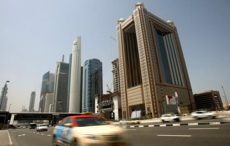 Cars drive past skyscrapers on Sheikh Zayed Road in the Gulf emirate of Dubai. The Dubai investment company Dubai World agreed on Thursday to restructure around $23.5 billion in debt, to reduce its debt obligations by nearly 40 percent. (Karim Sahib/AFP/Getty Images) Cars drive past skyscrapers on Sheikh Zayed Road in the Gulf emirate of Dubai. The Dubai investment company Dubai World agreed on Thursday to restructure around $23.5 billion in debt, to reduce its debt obligations by nearly 40 percent. (Karim Sahib/AFP/Getty Images)