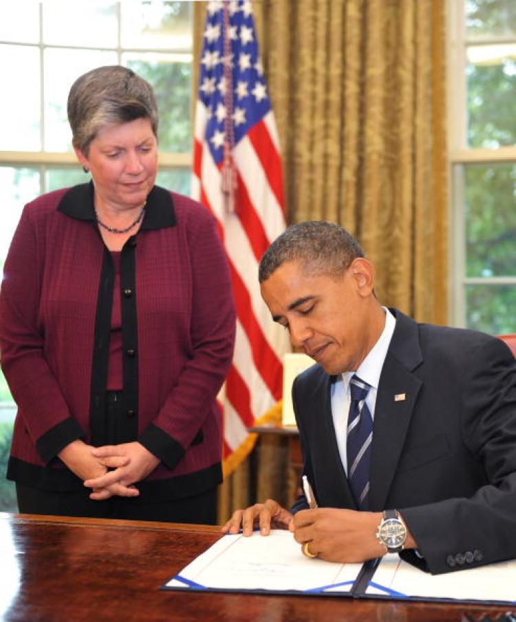 US President Barack Obama signs the Southwest Border Security Bill as Homeland Security Secretary Janet Napolitano looks on August 13, 2010 in the Oval Office of the White House in Washington, DC. (Mandel Ngan/AFP/Getty Images)