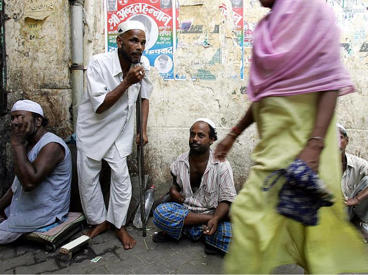 An Indian woman walks past beggars in New Delhi. (Christophe Archambault/AFP/Getty Images) An Indian woman walks past beggars in New Delhi. (Christophe Archambault/AFP/Getty Images)