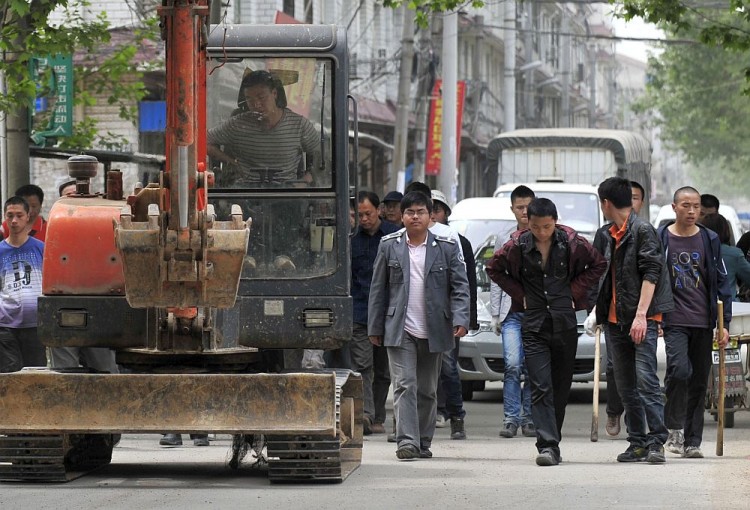 Chinese authorities carry sticks as they prepare to stand guard before workers demolish houses which are claimed illegal by local government in Wuhan, central China's Hubei Province on May 7, 2010. Land seizures have been a problem for years in China and forced evictions have not been uncommon. (AFP/Getty Images) Chinese authorities carry sticks as they prepare to stand guard before workers demolish houses which are claimed illegal by local government in Wuhan, central China's Hubei Province on May 7, 2010. Land seizures have been a problem for years in China and forced evictions have not been uncommon. (AFP/Getty Images)