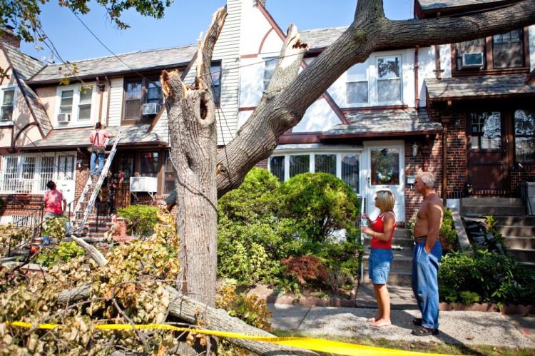 Donna-Marie Goedtel and neighbour, Teddy Cleanthes, look on as workers repair damage done to Goedtel's Forest Hills home. (The Epoch Times) Donna-Marie Goedtel and neighbour, Teddy Cleanthes, look on as workers repair damage done to Goedtel's Forest Hills home. (The Epoch Times)