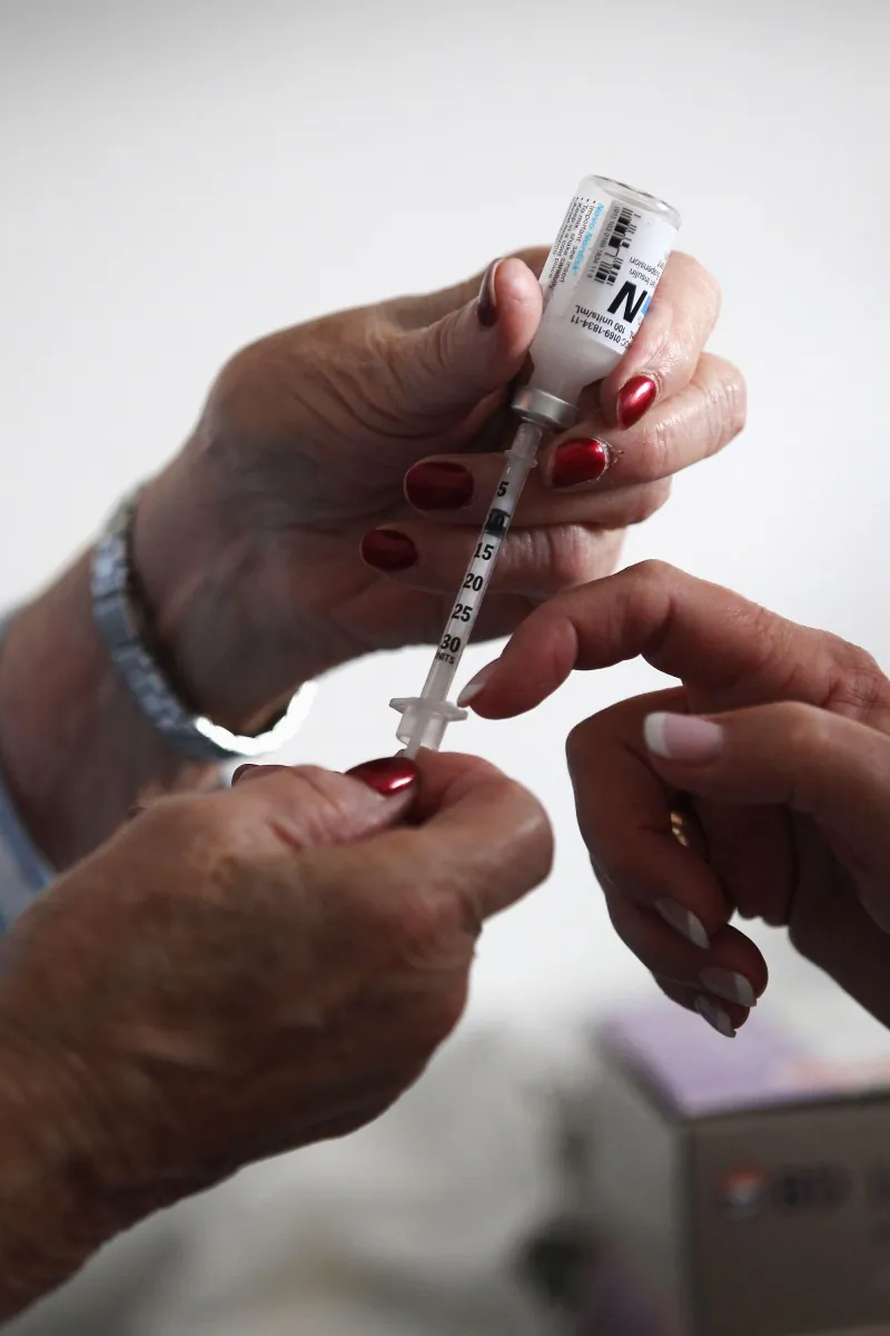 A nurse teaches a diabetes patient how to do her own insulin injections. (John Moore/Getty Images)