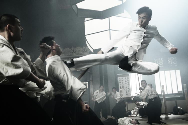 DROPKICK: Donnie Yen jump kicks a Japanese martial artist in 'Legend of the Fist: The Return of Chen Zhen.' DROPKICK: Donnie Yen jump kicks a Japanese martial artist in 'Legend of the Fist: The Return of Chen Zhen.'