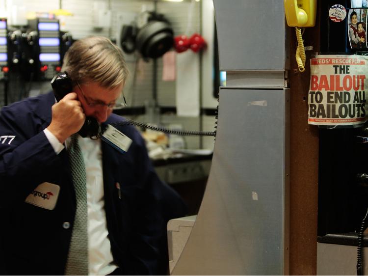 A financial professional uses a telephone on the floor of the New York Stock Exchange near the end of the day's trading January 7, 2009 in New York City. (Chris Hondros/Getty Images) A financial professional uses a telephone on the floor of the New York Stock Exchange near the end of the day's trading January 7, 2009 in New York City. (Chris Hondros/Getty Images)