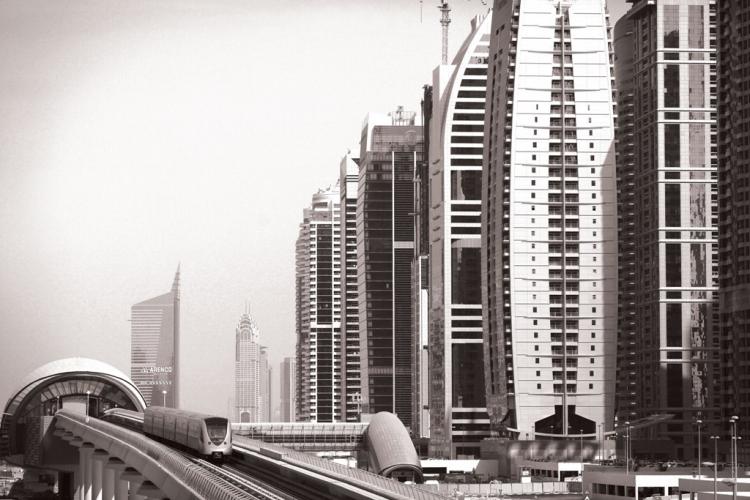 A passenger train passes in front of high rise buildings on December 2, in Dubai, United Arab Emirates. Neighbor Abu Dhabi bailed Dubai out with a handout of US$10 billion. (Dan Kitwood/AFP/Getty Images ) A passenger train passes in front of high rise buildings on December 2, in Dubai, United Arab Emirates. Neighbor Abu Dhabi bailed Dubai out with a handout of US$10 billion. (Dan Kitwood/AFP/Getty Images )