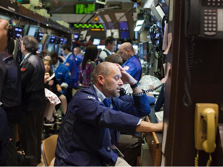 Traders work the floor at the New York Stock Exchange on November 27, 2009 in New York City. U.S. markets dropped on Friday, reacting to global worries over Dubai's debt problems. (Michael Nagle/Getty Images) Traders work the floor at the New York Stock Exchange on November 27, 2009 in New York City. U.S. markets dropped on Friday, reacting to global worries over Dubai's debt problems. (Michael Nagle/Getty Images)