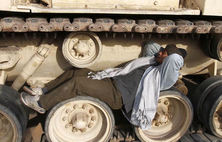 An Egyptian anti-government demonstrator sleeps on the wheels of a military vehicle at Cairo's Tahrir square on February 6, 2011 on the 13th day of protests calling for the ouster of President Hosni Mubarak. (AFP/Getty Images)