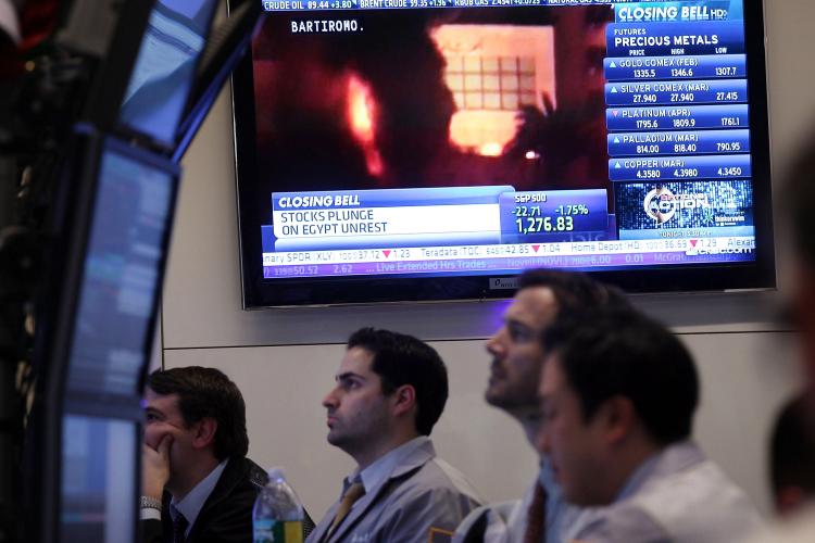 With a television screen showing images of the unrest in Egypt, traders work on the floor of the New York Stock Exchange (NYSE) at the end of the trading day on Jan. 28 in New York City. As investors fears of the protests in Egypt spread through the region, U.S. stocks fell Friday afternoon with the Dow losing 166 points. (Spencer Platt/Getty Images) With a television screen showing images of the unrest in Egypt, traders work on the floor of the New York Stock Exchange (NYSE) at the end of the trading day on Jan. 28 in New York City. As investors fears of the protests in Egypt spread through the region, U.S. stocks fell Friday afternoon with the Dow losing 166 points. (Spencer Platt/Getty Images)