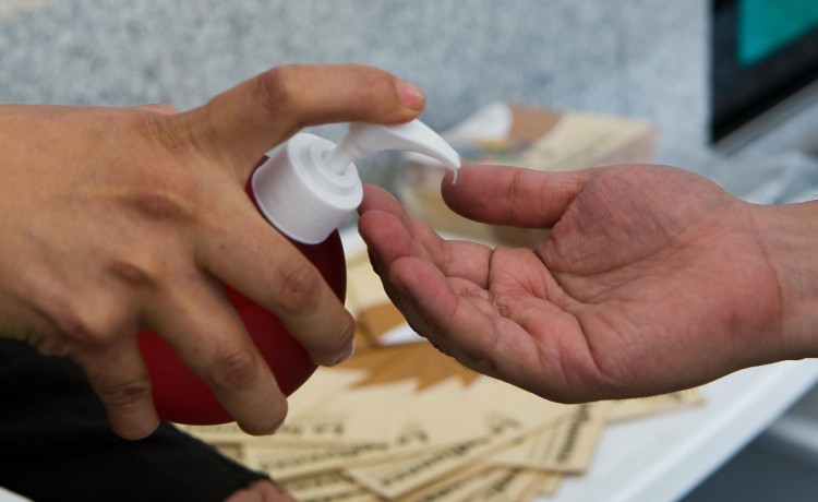 A metrobus personnel offers sanitize gel Epoch Times Photo