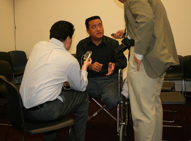 Fang Zheng speaks to reporters prior to a Capitol Hill press conference May 18 regarding the Chinese regime�s violent suppression of democracy demonstrators on Tiananmen Square June 4, 1989. As he was attempting to escape Tiananmen, a tank ran him down, (Gary Feuerberg/The Epoch Times) Epoch Times Photo