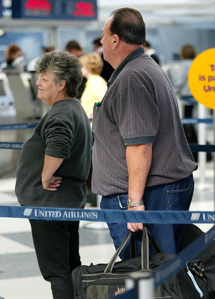 A heavy-set couple check in for a flight. (Tim Boyle/Getty Images) A heavy-set couple check in for a flight. (Tim Boyle/Getty Images)