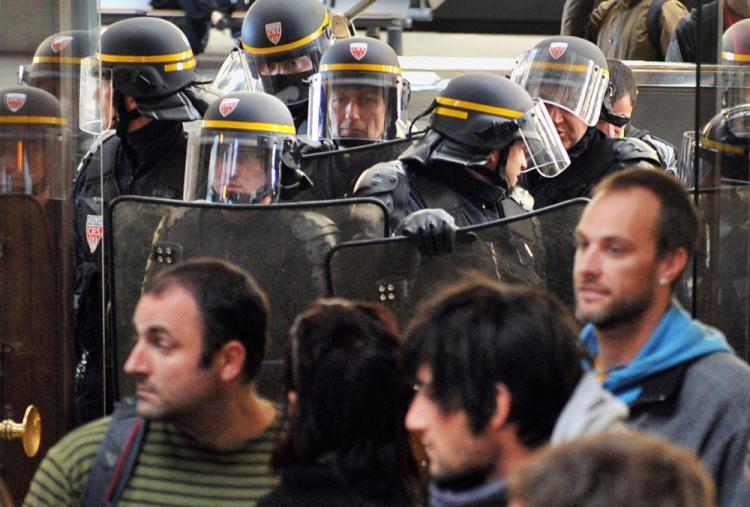 Anti-riot policemen contain some 800 on strike rail workers gathered at Bordeaux's Saint-Jean station on Oct. 22, 2010 to protest against the government's bid to hike the retirement age from 60 to 62. (Pierre Andrieu/AFP/Getty Images) Anti-riot policemen contain some 800 on strike rail workers gathered at Bordeaux's Saint-Jean station on Oct. 22, 2010 to protest against the government's bid to hike the retirement age from 60 to 62. (Pierre Andrieu/AFP/Getty Images)