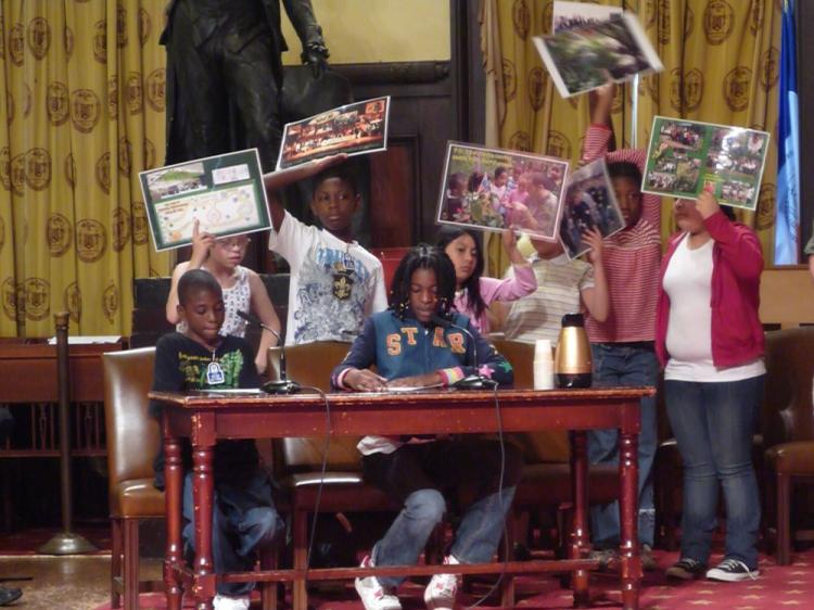 Students of the Garden Club at I.S. 155 show their support of protecting community gardens. They spoke at the City Council Chambers Wednesday. (Christine Lin/The Epoch Times)