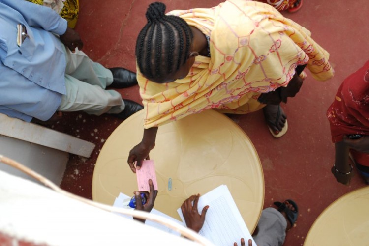 GETTING A RATION CARD: After being registered as an IDP in Wau, a woman receives her ration card, which will allow her to receive emergency food. (World Concern)