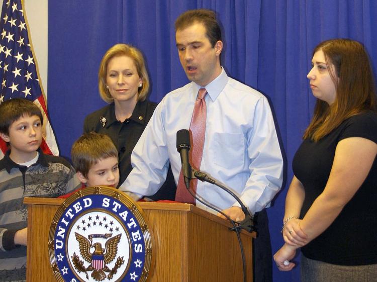 TAXED: John Lavelle (2nd R) tells of the financial hardship of his family. He is joined by his wife, Amy (R), and sons, Jacob (L) and Zachary (2nd L). The family's hardship has been exacerbated by rising property taxes, a problem Sen. Kirsten Gillibrand (C) hopes to remedy. (Tara MacIsaac/The Epoch Times) TAXED: John Lavelle (2nd R) tells of the financial hardship of his family. He is joined by his wife, Amy (R), and sons, Jacob (L) and Zachary (2nd L). The family's hardship has been exacerbated by rising property taxes, a problem Sen. Kirsten Gillibrand (C) hopes to remedy. (Tara MacIsaac/The Epoch Times)