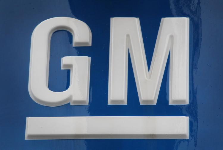 A General Motors Co. logo hangs above a Chevrolet dealership this past April in Chicago, Illinois. GM said on Tuesday that its July auto sales were up 5 percent from June.  (Scott Olson/Getty Images)