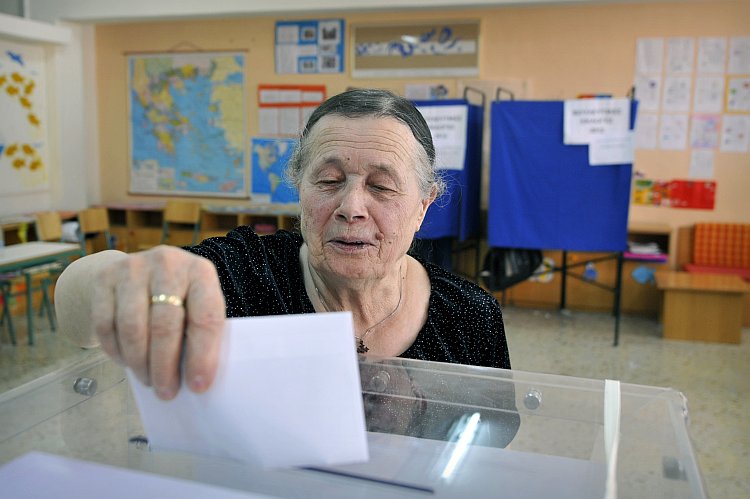 A woman casts her vote for Greece's general elections A woman casts her vote for Greece's general elections