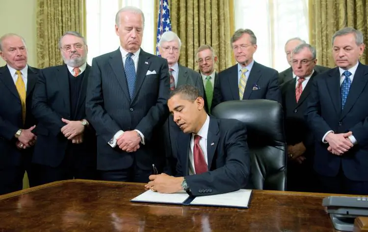 President Barack Obama signs an executive order related to the closing of the "War on Terror" prison at Guantánamo Bay, Cuba, during a ceremony in the Oval Office of the White House in Washington, D.C., on Jan. 22, 2009. (Saul Loeb/AFP/Getty Images)