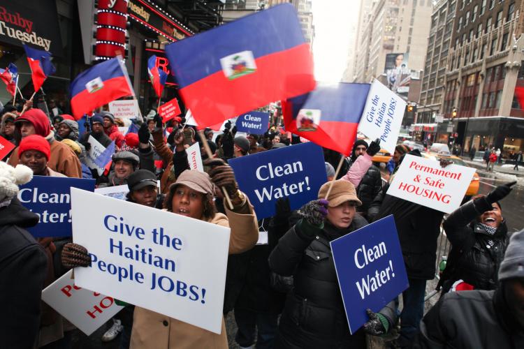 Marking the one-year anniversary of the massive earthquake in Haiti, Haitians and supporters rallied in Times Square and subsequently marched to the Haitian Consulate in New York City on Wednesday to urge faster relief for the country. (Amal Chen/The Epoch Times) Marking the one-year anniversary of the massive earthquake in Haiti, Haitians and supporters rallied in Times Square and subsequently marched to the Haitian Consulate in New York City on Wednesday to urge faster relief for the country. (Amal Chen/The Epoch Times)