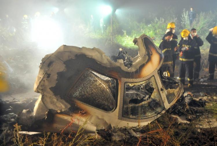 Chinese firefighters search the cockpit of the Henan Airlines ERJ-190 jet wreckage at the crashsite in the northeast city of Yichun in remote Heilongjiang province early on August 25, 2010. A large number of Chinese pilots falsify their flight credentials in order to land better jobs. (STR/AFP/Getty Images) Chinese firefighters search the cockpit of the Henan Airlines ERJ-190 jet wreckage at the crashsite in the northeast city of Yichun in remote Heilongjiang province early on August 25, 2010. A large number of Chinese pilots falsify their flight credentials in order to land better jobs. (STR/AFP/Getty Images)