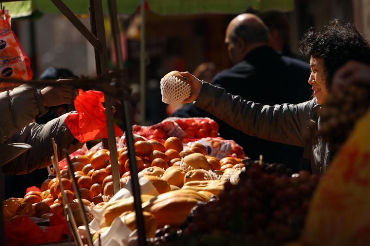 People buy produce at a New York City market in this file photo. A report says access to fresh fruits and vegetables over fast food may be a factor in community health statistics.  (Spencer Platt/Getty Images)