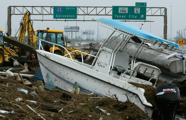 IKE AFTERMATH: Heavy equipment starts to move boats and other debris off of Rt.45 left by Hurricane Ike September 13, 2008 in Galveston, Texas. Hurricane Ike made landfall in the middle of the night causing wide spread damage to the Texas coast. (Mark Wilson/Getty Images ) IKE AFTERMATH: Heavy equipment starts to move boats and other debris off of Rt.45 left by Hurricane Ike September 13, 2008 in Galveston, Texas. Hurricane Ike made landfall in the middle of the night causing wide spread damage to the Texas coast. (Mark Wilson/Getty Images )