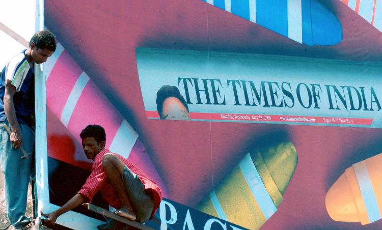Indian workers puting up a billboard advertising a newspaper on 19 May 2005 in Mumbai. (Indranil Mukherjee/AFP/Getty Images) Indian workers puting up a billboard advertising a newspaper on 19 May 2005 in Mumbai. (Indranil Mukherjee/AFP/Getty Images)