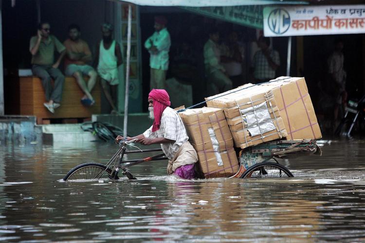 Indian commuters make their way through a waterlogged street after a heavy downpour flooded parts of Amritsar on August 13, 2008. (Narinder Nanu/AFP/Getty Images) Indian commuters make their way through a waterlogged street after a heavy downpour flooded parts of Amritsar on August 13, 2008. (Narinder Nanu/AFP/Getty Images)