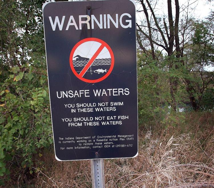 A sign warns people not to swim or fish in a waterway near the United States Steel Gary Works plant October in Gary, Ind. (Scott Olson/Getty Images)