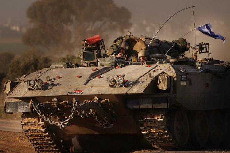 Israeli soldiers ride in a armored personnel carrier (APC) along the Israeli, Gaza border in Israel. (Spencer Platt/Getty Image) Israeli soldiers ride in a armored personnel carrier (APC) along the Israeli, Gaza border in Israel. (Spencer Platt/Getty Image)