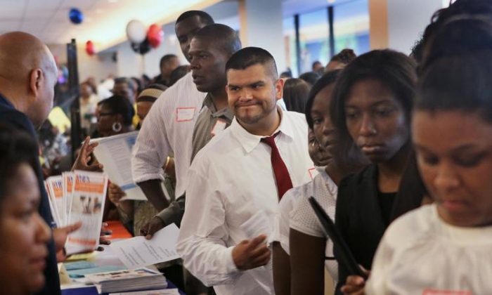 Job seekers speak with recruiters during a career fair at Malcolm X College on June 23, 2018 in Chicago, Illinois. (Scott Olson/Getty Images)